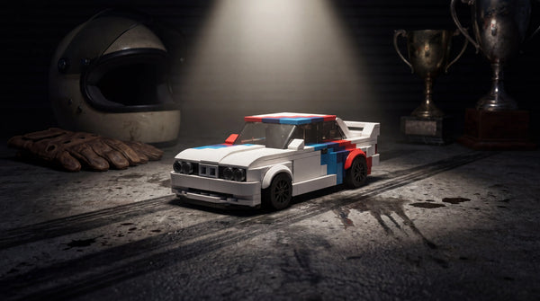 BMW M3 E30 1:24 scale LEGO-compatible brick building kit in racing garage — Rova LEGO BMW M3 building kit covering every M3 generation E30 E46 M4