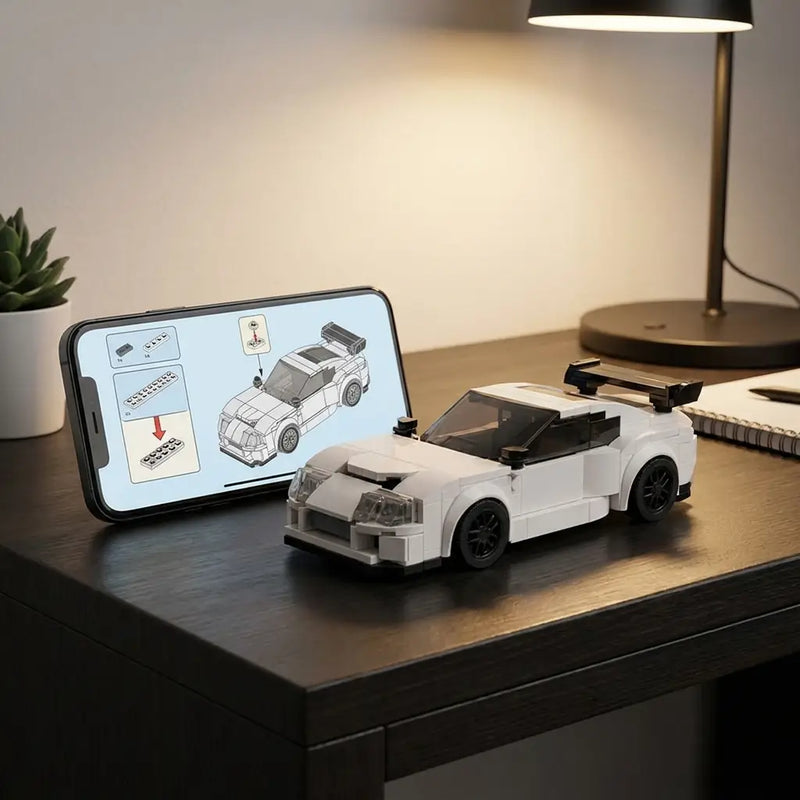 Rova Toyota Supra Mk4 LEGO-compatible brick kit with digital step-by-step instructions on smartphone — scan QR code to access building instructions